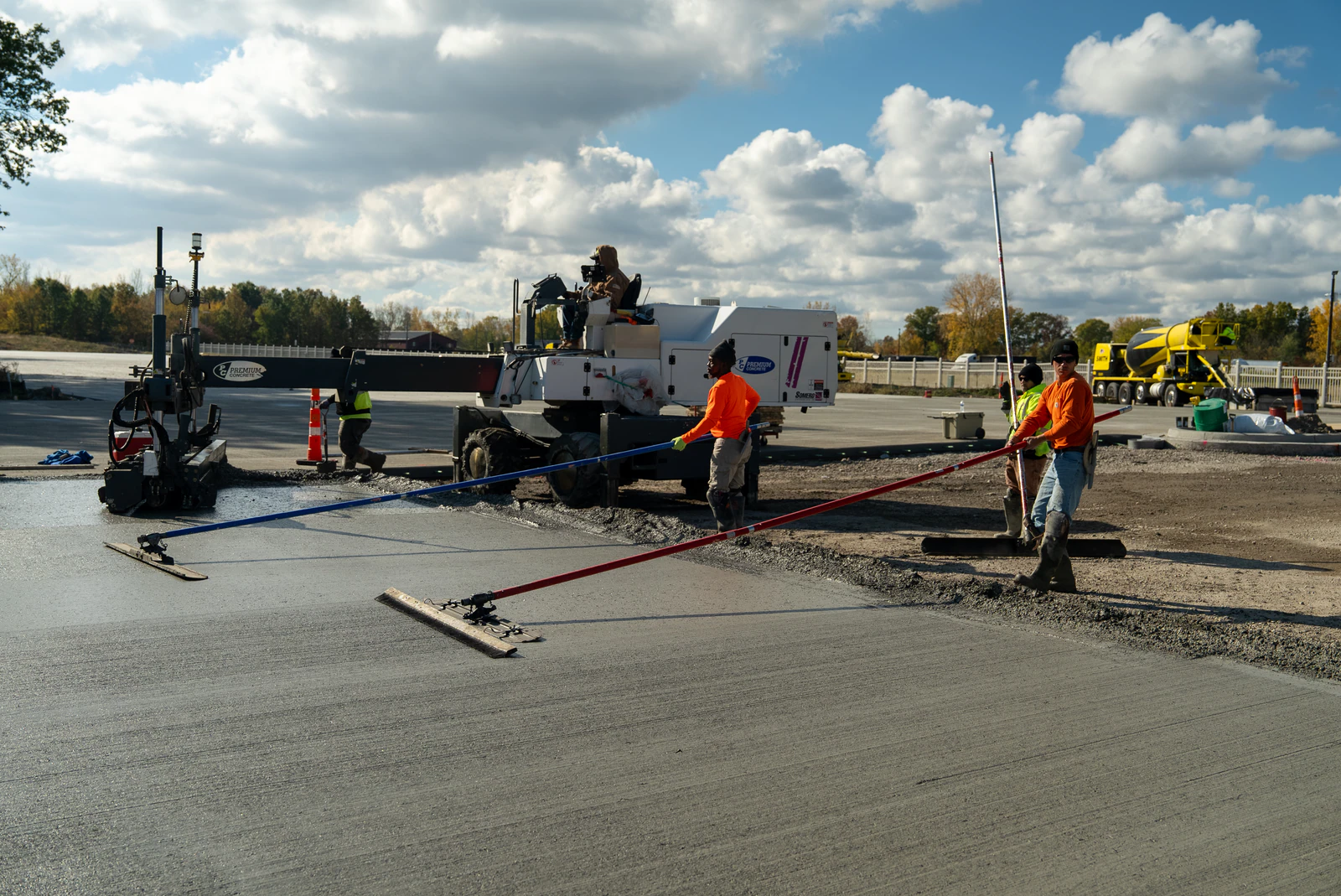Advantage Paving concrete crew placing and finishing a fresh concrete slab at a commercial site